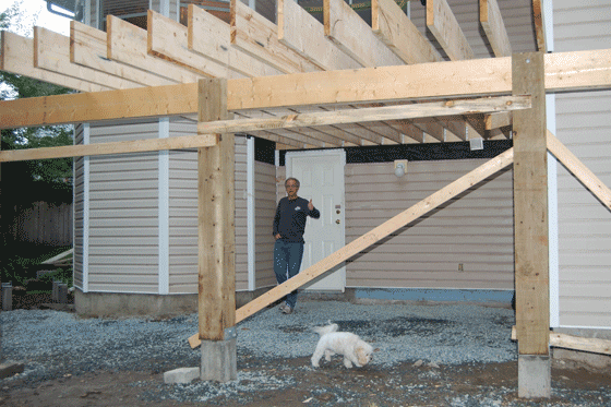 Picture of concrete footings, post, beam and joists for the new deck